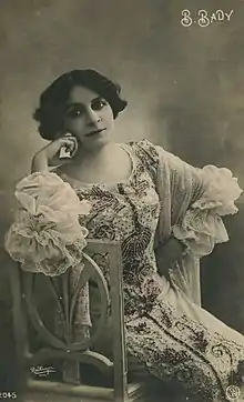 sepia-toned photograph of Berthe Bady, seated in a dressing gown
