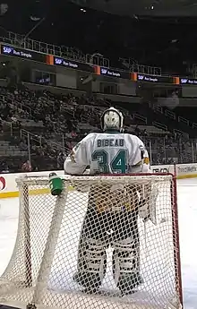 Bibeau stands with his back to the net waiting for a face-off.