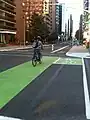 Cycle track with green lanes through intersection in Ottawa, Ontario, Canada (also on Laurier) in 2011.