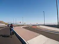 Cyclist rides through the main lane of roundabout
