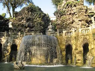 The statue of the Sibyl Albunensa over the fountain, and the artificial mountains behind it.