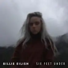 The cover features Eilish standing in front of mountains, surrounded by fog