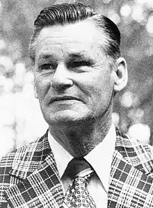 A man in a dark and light plaid suit jacket