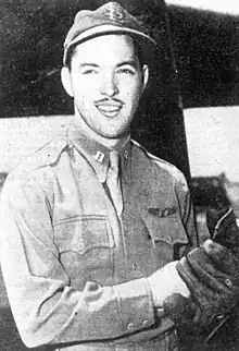 A man in military uniform wearing a baseball cap