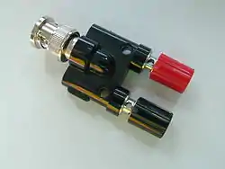 Adapter between five-way binding posts and a male BNC connector manufactured by Pomona.