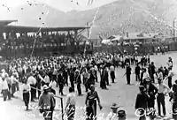 Deportation of striking miners from Bisbee, Arizona, on July 12, 1917. The miners and others who have been rounded up are assembled at Warren Ballpark and are sitting in the bleachers while armed members of the posse stand in the infield.