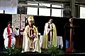 Bishop Ngarahu Katene (seated) listens as Hineoripo Waenga reads from the Bible at an annual Confirmation Service in 2019.