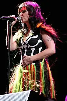Björk holding a microphone in her right hand.