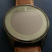 Front side of a black Olio Model One smartwatch with a brown leather strap