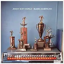 A collection of bowling trophies sitting on top of a cigarette machine