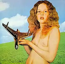 a topless pubescent girl, holding in her hands a stylized silver aircraft