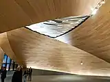 Wooden lobby with metallic sculpture in the ceiling