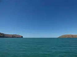 Godley Head (left) and Te Piaka / Adderley Head (right), as seen from Lyttelton Harbour / Whakaraupō