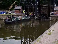 Canal boat entering the River Weaver from the base of the boat lift.