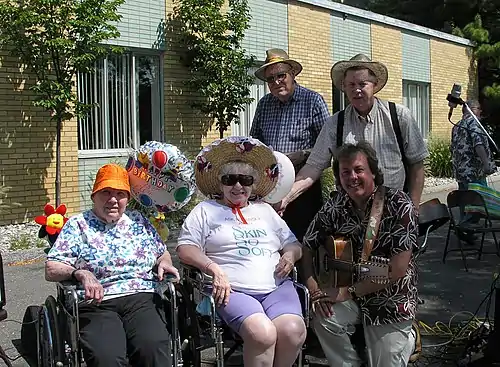 Bob and the Green Valley Boys pose with some residents after a concert in Battle Creek Michigan
