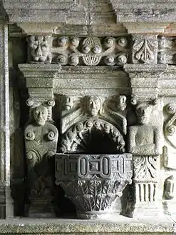 A stoup in the frieze below the statues of the apostles in the south porch interior