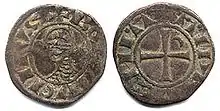 An old coin depicting a head on one side and a cross on the other side