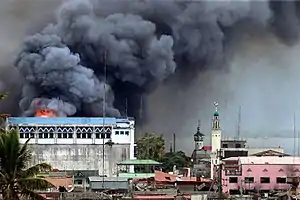 A building in Marawi is set ablaze by air strikes carried out by the Philippine Air Force.