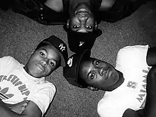 Boogie Down members in 1987, Scott La Rock (Nike hat), KRS-One (Kangol bucket hat), and D-Nice (New York Yankees hat)