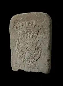 Raised stone on a black background, marked with a partially hammered crowned wheel.