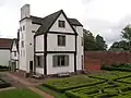 The hunting lodge, framed by its own chimney stack and stairway.