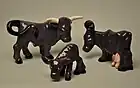 Brayton Laguna purple bull, cow, and calf figurines based on the poem Purple Cow by Gelett Burgess.