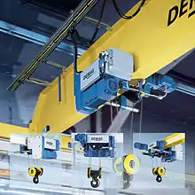 Overhead crane and hoist mounted on a trolley that can be moved across the bridge beam