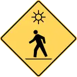 Crosswalk with flashing lights ahead.