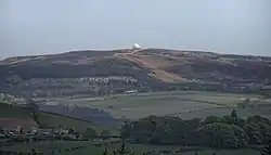 A shot looking across to a small radome, on a hill, in the distance