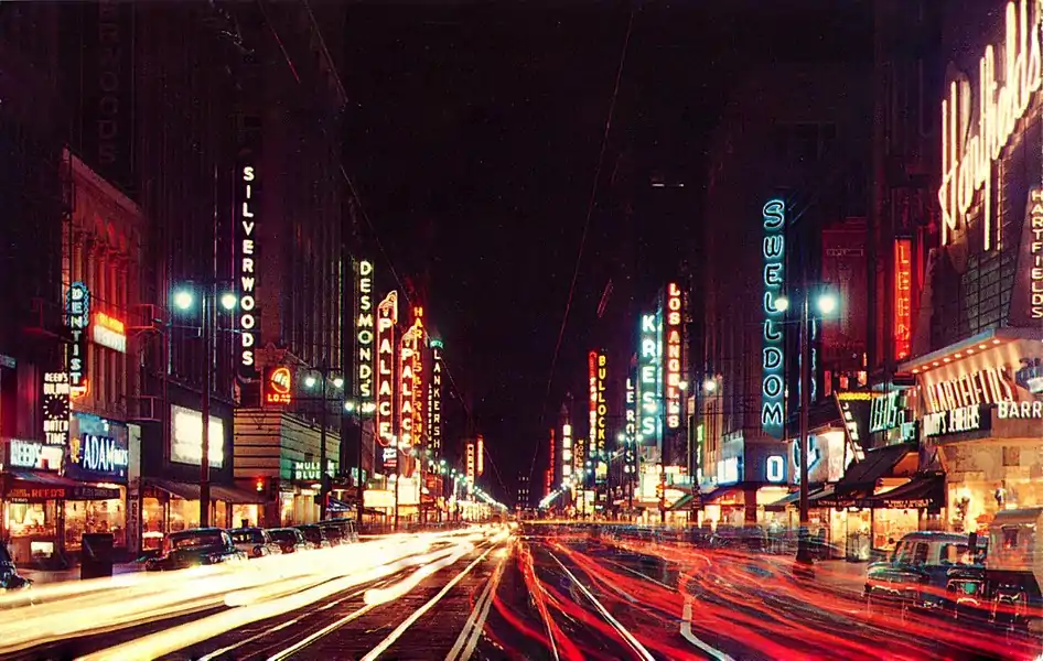 Broadway at night, 1950s, looking south from 5th Street. Visible are Hartfield's at #537, the Los Angeles Theatre, Silverwoods and Swelldom at the corner of 6th; the Palace Theatre, Harris & Frank and Desmond's in the 600 block; Bullock's and the Hotel Lankershim at the corner of 7th.