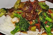 Broccoli beef on a rice bed