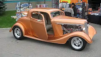 1934 Ford 3-window with a deeply chopped top, monochrome, spoke rims, and suicide doors