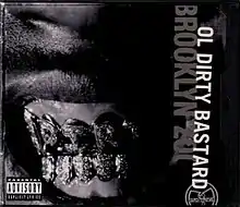 The cover is shown in black-and-white with the artist's name and title cover shown sideways on the right side and an image of ODB's golden grillz is shown in the center.