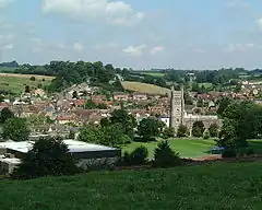 Bruton view from the Dovecote. St. Mary's church stands out with its grand tower. The London to Penzance railway line cuts through the town just below the hill, out of view.