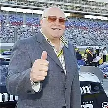 Ollen Bruton Smith at Texas Motor Speedway in 2005, displaying a thumbs-up gesture