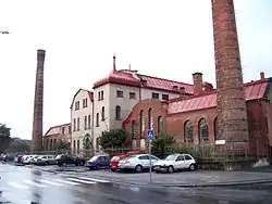 Front view of the plant with two red brick chimneys