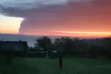 The smoke plume from the 2005 Hertfordshire Oil Storage Terminal fire as seen from Dunsmore, Buckinghamshire, about 14 miles (23 km) away.