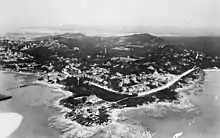 View of a coastal city from a high-altitude point at sea