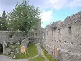 Educational representation of a medieval mason on the north wall of the inner ward