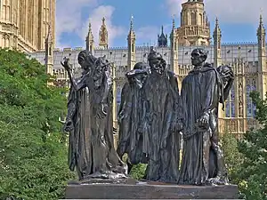 The London cast of The Burghers of Calais, with the Palace of Westminster in the background