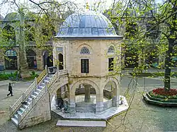The courtyard of the Koza Han (1490–91) of Bursa, Turkey; the domed building is a small mosque (mescit)