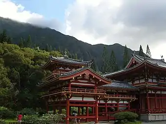 Mist-capped mountains loom above the temple.