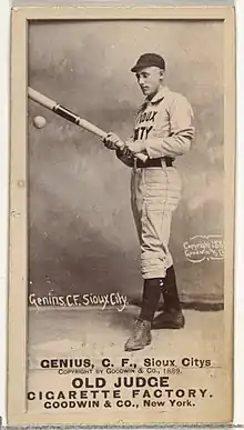 Standing man in baseball uniform with bat