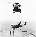 CH-53 Sea Stallion carrying an OV-10 Bronco over USS Iwo Jima in 1980.
