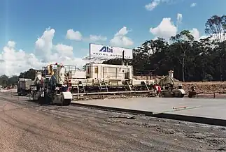 A large concrete slipform road paver