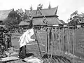 A Karo-Batak shaman performs rituals with a wand, egg and chameleon in a ceremony in the village "Kabanjahe" Sumatra. In the background the house of Pa Mbelgah