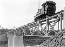 A steam locomotive runs on a railway bridge of the private-owned Dutch East Indies Railway Company on the line between Secang, Magelang and Parakan, Temanggung, Central Java