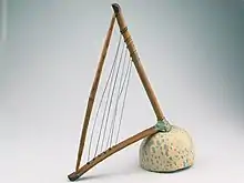 The Loma or belly harp has the appearance of an angle harp or lyre. However it is a frame zither.