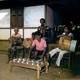 Tifa drums being played with totobuang gong chimes, in a tifa totobuang combination.