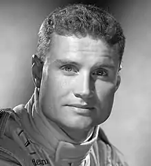 Black and white studio portrait photograph of David Coulthard in racing uniform